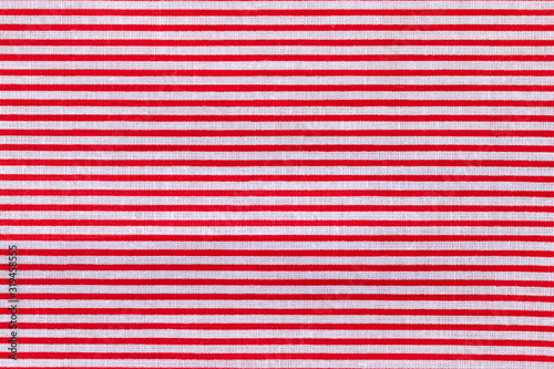 Red and white horizontal striped fabric texture. Bright colored cotton background