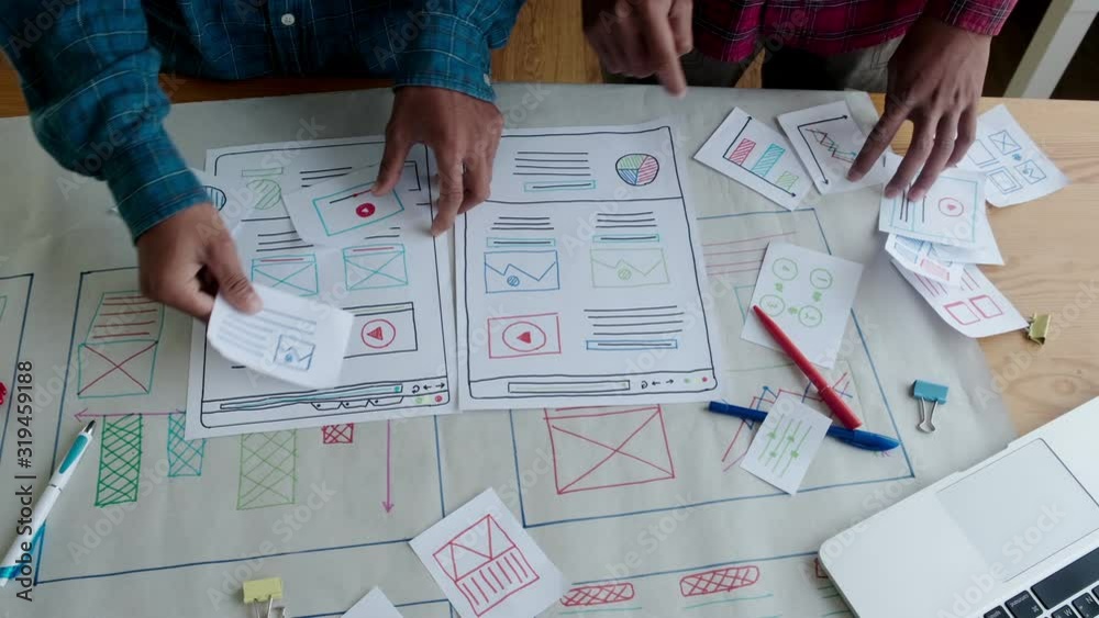 Web designer working laptop responsive design. Creative UI Ux designer teamwork meeting planning designing wireframe layout application development for smartphone screen mobile phone technology