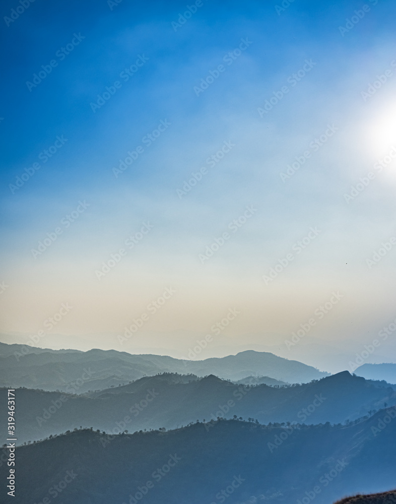 Green mountains in the fog. Seamless background. 
