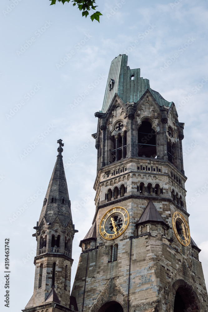 Obraz premium View of Kaiser Wilhelm Memorial Church. The Memorial Church today is a famous landmark of western Berlin. Ruin of the imperial church, not rebuilt as a reminder of World War II.