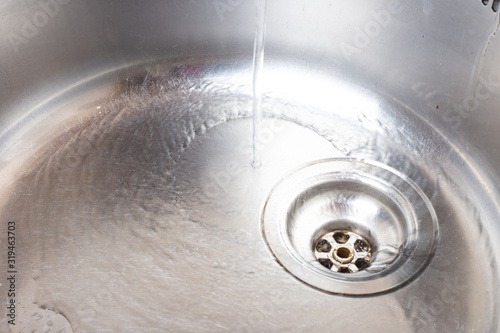Water pours into the metal sink