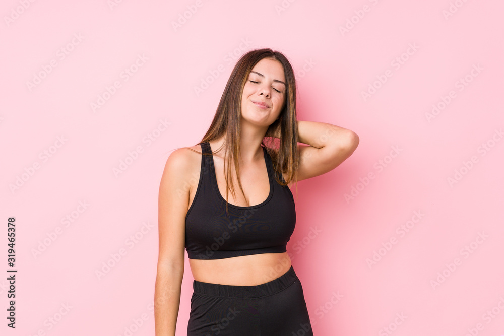 Young fitness caucasian woman isolated suffering neck pain due to sedentary lifestyle. Young fitness caucasian woman isolated suffering neck pain due to sedentary lifestyle.