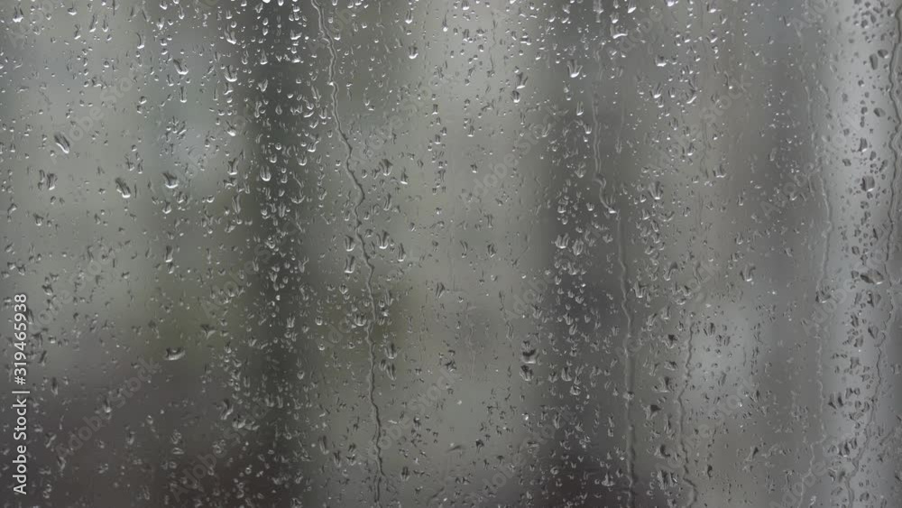 Closeup view of wet glass of window and nasty weather outdoors. Wet snow and rain falling down simultaneously. Closeup view of wet glass of window and nasty weather outdoors. Wet snow and rain falling down simultaneously.
