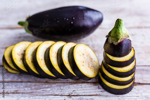 Sliced eggplant on a wooden background.