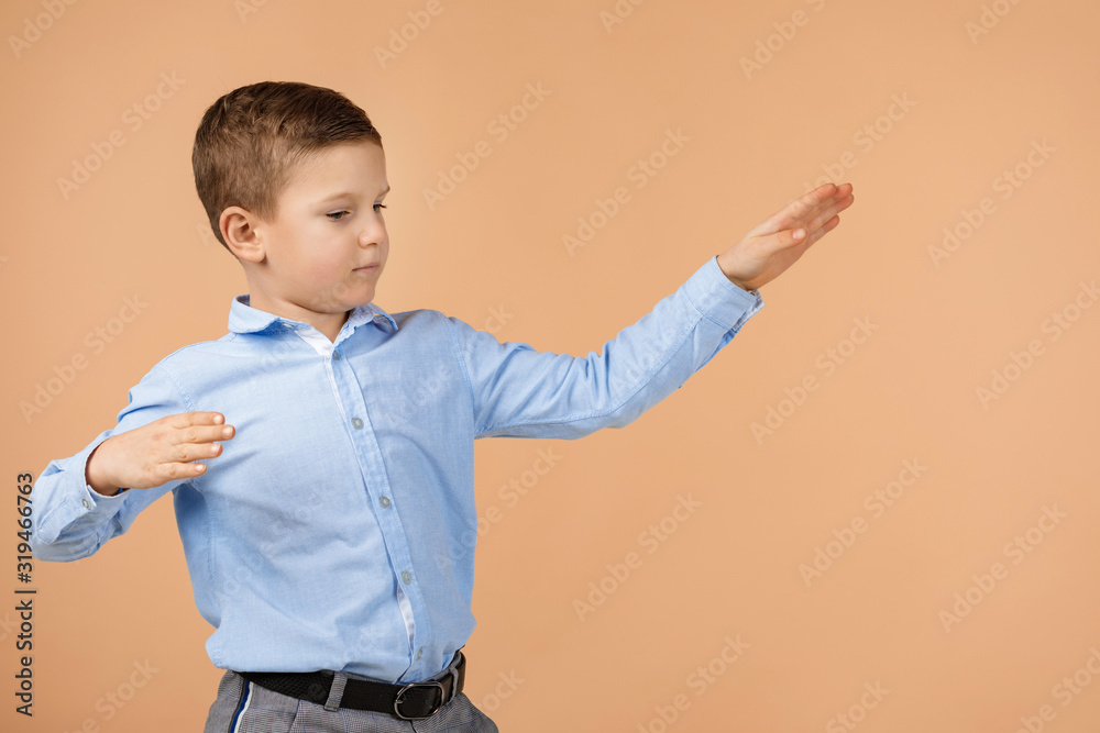 little cute school boy dancing over soft yellow background. happy back to school little cute school boy dancing over soft yellow background. happy back to school