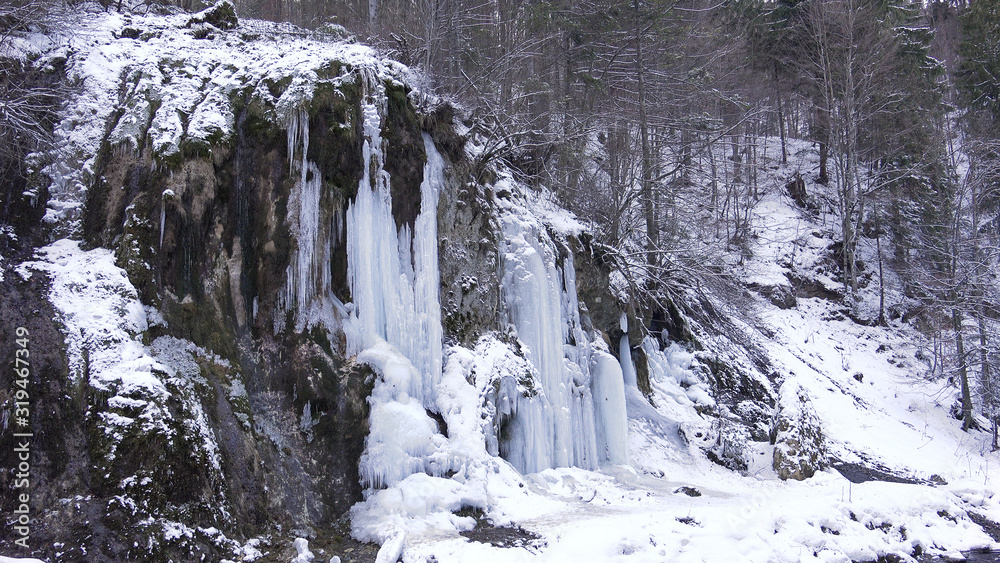Frosted Waterfall Brook in Winter, Creek Icicle on Mountain Cliffs, Frozen Snow Frosted Waterfall Brook in Winter, Creek Icicle on Mountain Cliffs, Frozen Snow