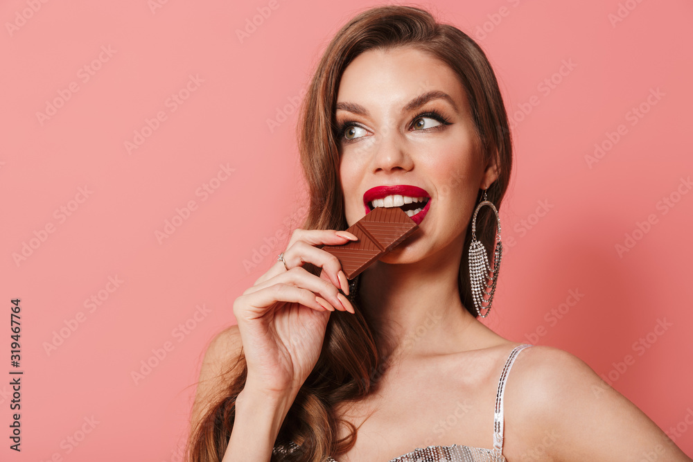Woman in bright sequins dress holding chocolate. Woman in bright sequins dress holding chocolate.