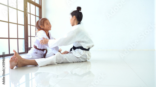 Teacher teaching taekwondo girl