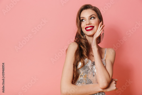Cheery young woman in bright sequins dress