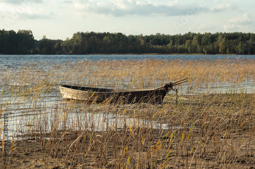 Boat moored on the mudy shore lake photo