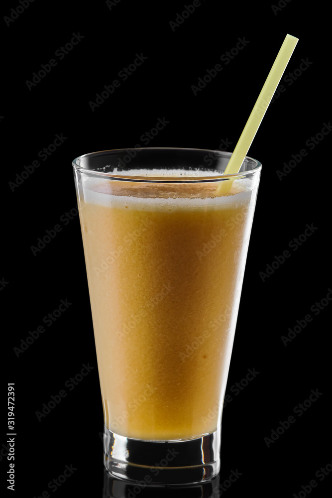 Glass of orange and banana smoothie isolated on black background Glass of orange and banana smoothie isolated on black background