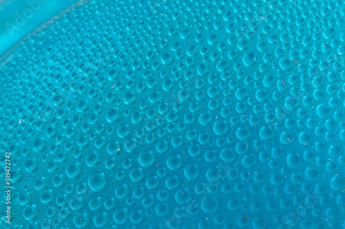 Blue water drops background close up