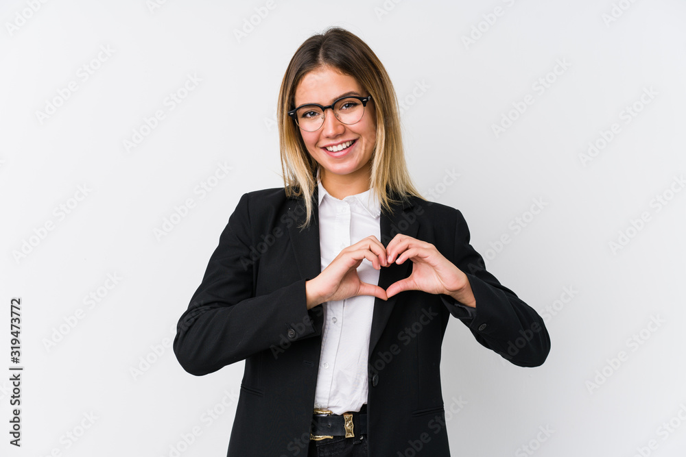 Young business caucasian woman smiling and showing a heart shape with hands. Young business caucasian woman smiling and showing a heart shape with hands.