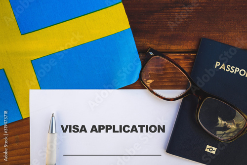 Flag of Sweden, visa application form and passport on table