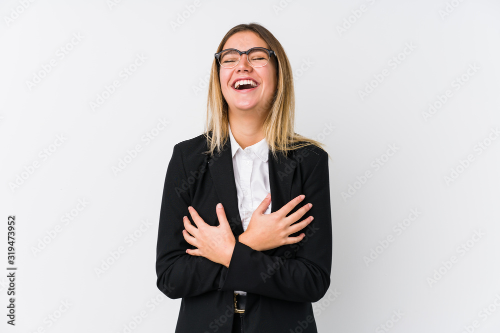 Young business caucasian woman laughs happily and has fun keeping hands on stomach. Young business caucasian woman laughs happily and has fun keeping hands on stomach.