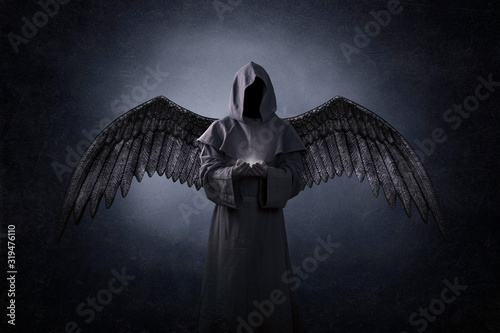 Angel of death with soul in hands in the dark