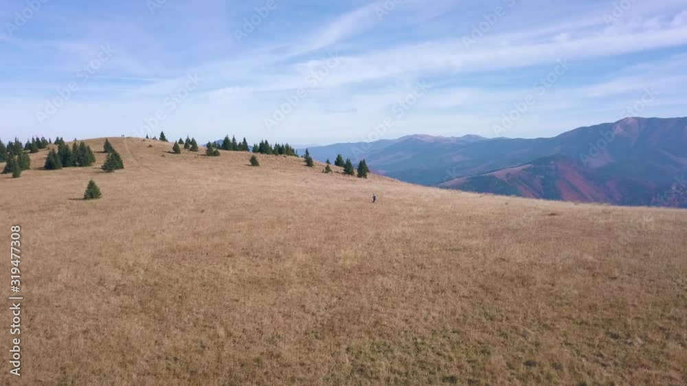 Man hiking on a top of the mountain with beautiful views at the end. Reveal shot with drone. Fly over. Man hiking on a top of the mountain with beautiful views at the end. Reveal shot with drone. Fly over.