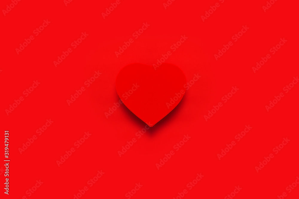 Red gift box in the shape of heart on red background top view Flat lay. Creative composition for Valentine's Day, love concept, birthday present, mother day, March 8, holiday background