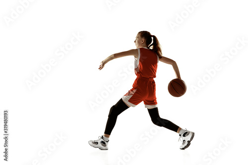 Young caucasian female basketball player in action  motion in run isolated on white background. Redhair sportive girl. Concept of sport  movement  energy and dynamic  healthy lifestyle. Training.
