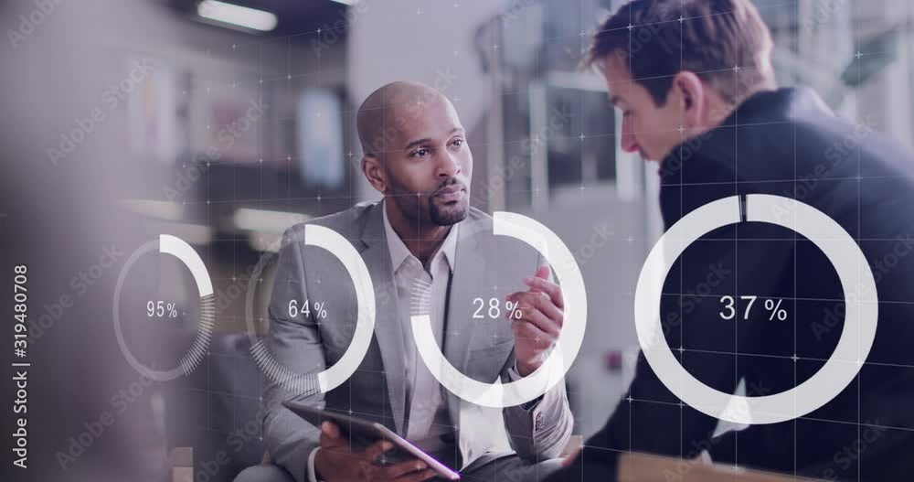 Digital composite of diverse business people in a meeting in office using digital tablet with graphics moving over the screen