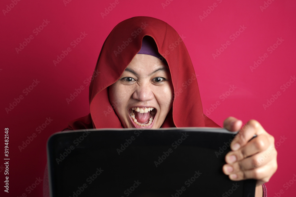 Angry Muslim Businesswoman Working on Laptop at the Office Angry Muslim Businesswoman Working on Laptop at the Office