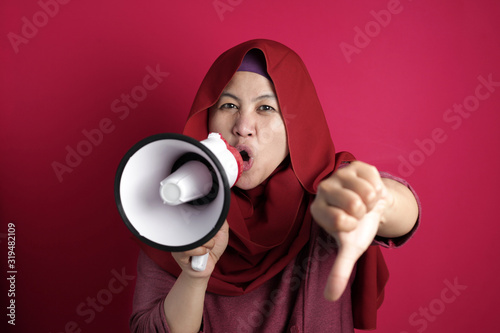 Young Businesswoman Angry, Screaming on Megaphone with Thumb Down gesture