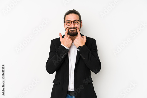 Young caucasian business man isolated on a white background doubting between two options.