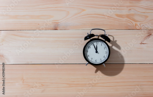 Vintage alarm clock on wooden background