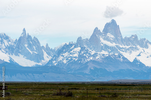 Panoramic views of Mount Fitz Roy on a sunny day over a cloudy sky. El Chalten, Patagonia, Argentina