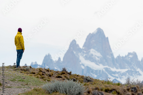 Alone hiker with yellow jacket admiring views over Mount Fitz Ro © Bisual Photo