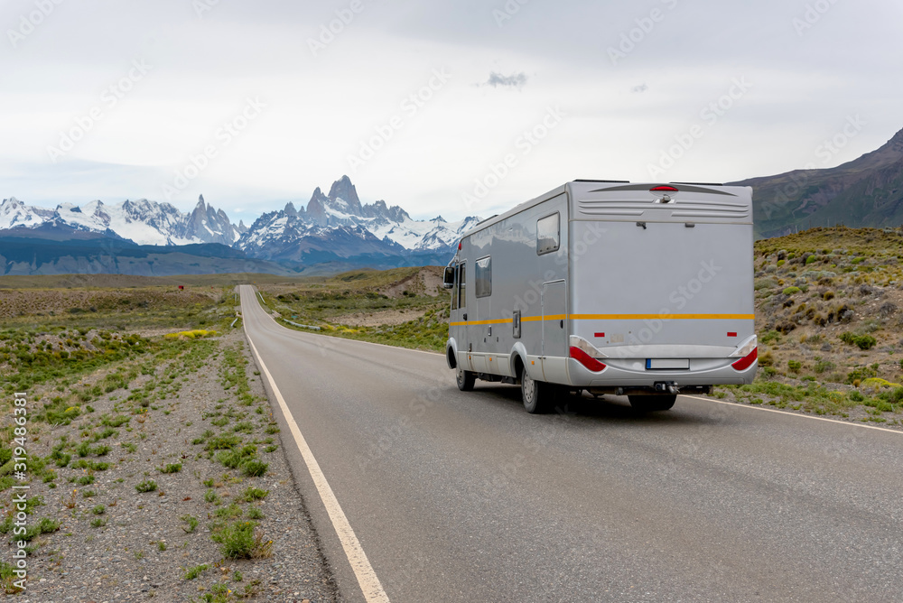 Mobile home truck traveling on the road in Patagonia with the Mount Fitz Roy on the background