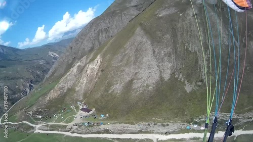 Paragliding over the tops of snow-capped mountains