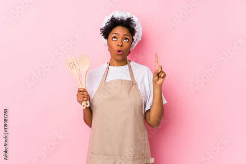 Young african american cook woman having some great idea, concept of creativity.