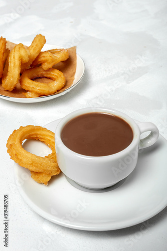 Cup of chocolate sauce with churros
