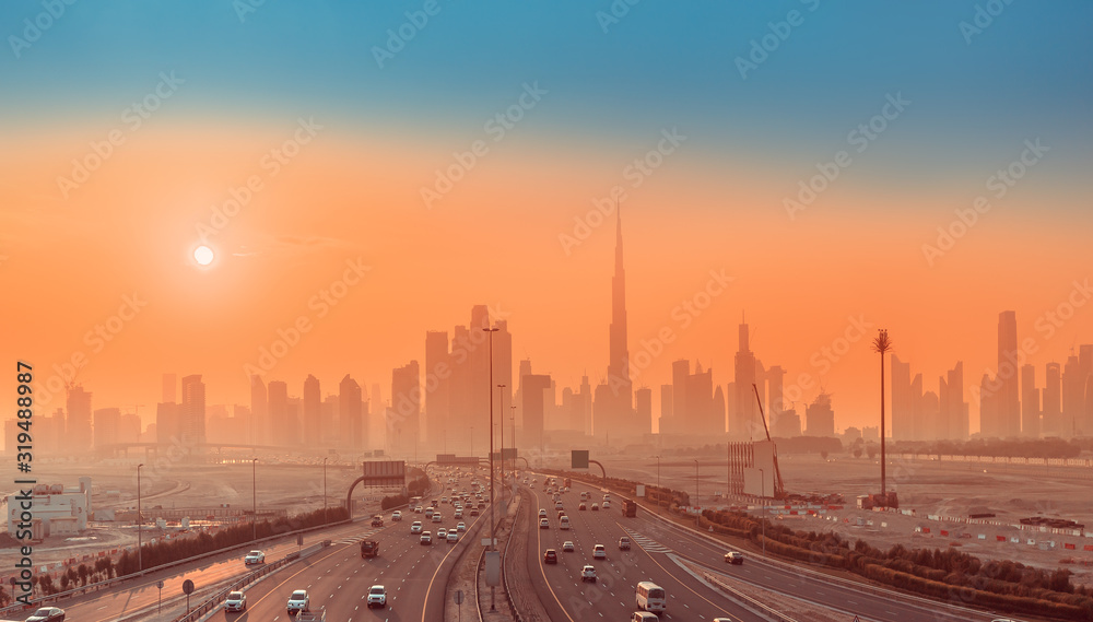 Highway Road and Dubai cityscape skyline at sunset. Transportation and travel in UAE concept Highway Road and Dubai cityscape skyline at sunset. Transportation and travel in UAE concept
