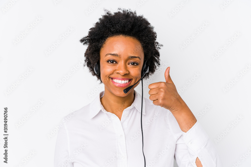 Young african american telemarketer woman isolated smiling and raising thumb up Young african american telemarketer woman isolated smiling and raising thumb up