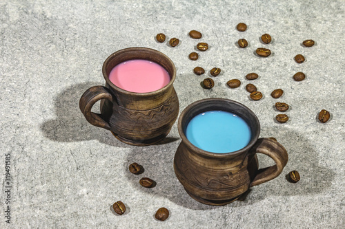 Trendy drink blue and pink latte. Lavender or spirulina and rose, beetroot or raspberry coffee. Stone concrete background