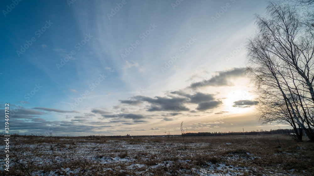 Beautiful setting sun over frozen field Beautiful setting sun over frozen field