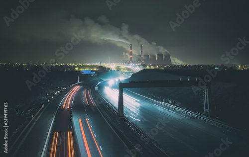 Ferrybridge power station with light trails on the dual carriageway. photo