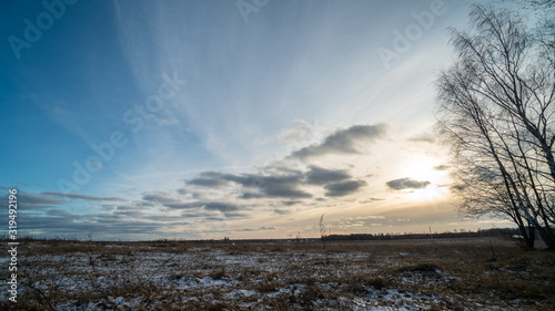 Beautiful setting sun over frozen field