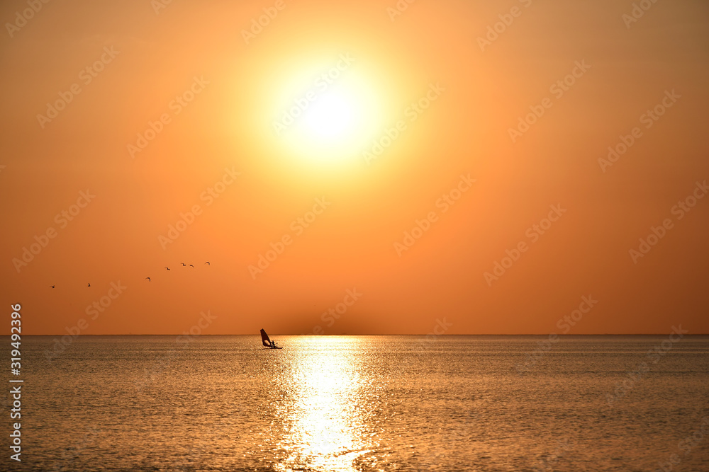 Sunset and sunny track on the water surface