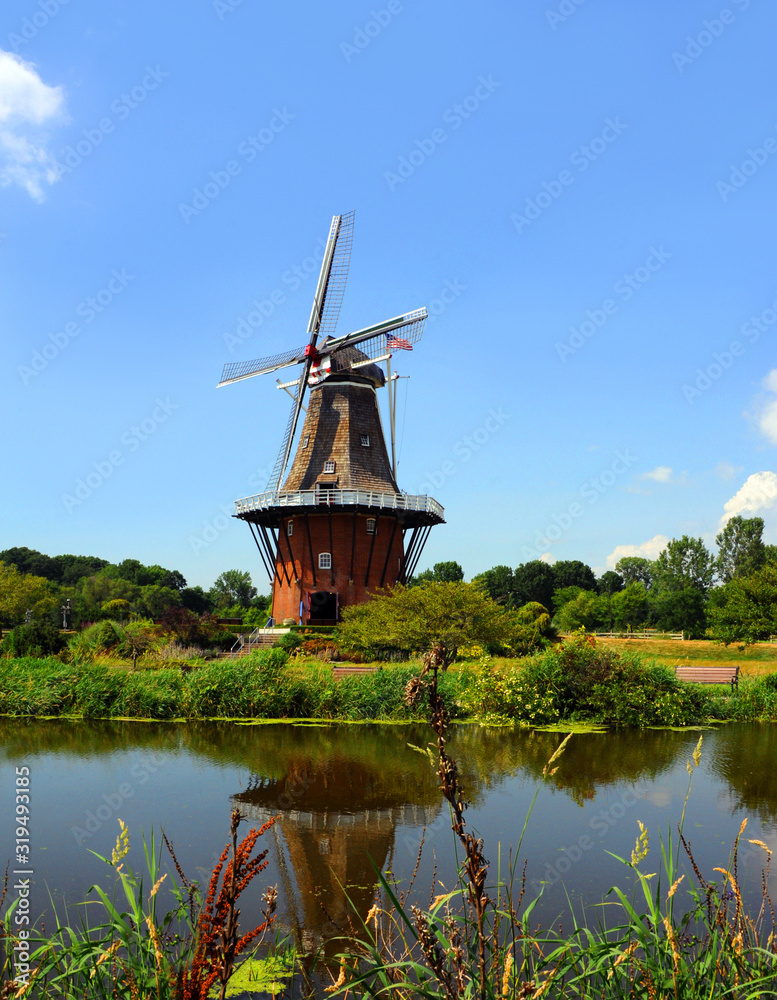 Canal Reflects DeZwaan Dutch Windmill