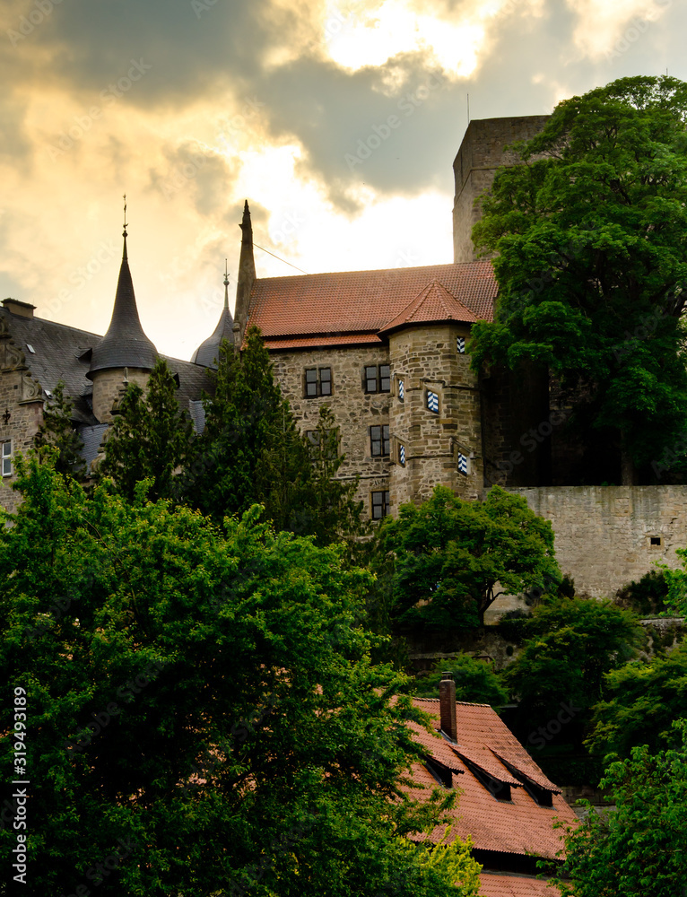 Obraz premium The ancient castle Adelebsen (Burg Adelebsen) in the middle of Germany, Europe with beautiful sky and clouds and backlight