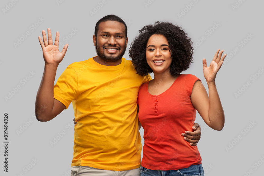 Fototapeta premium relationships and people concept - happy african american couple hugging over grey background