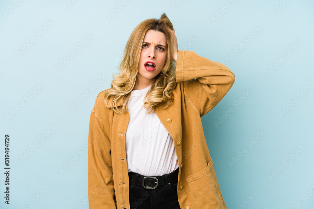 Young blonde pretty woman isolated tired and very sleepy keeping hand on head. Young blonde pretty woman isolated tired and very sleepy keeping hand on head.