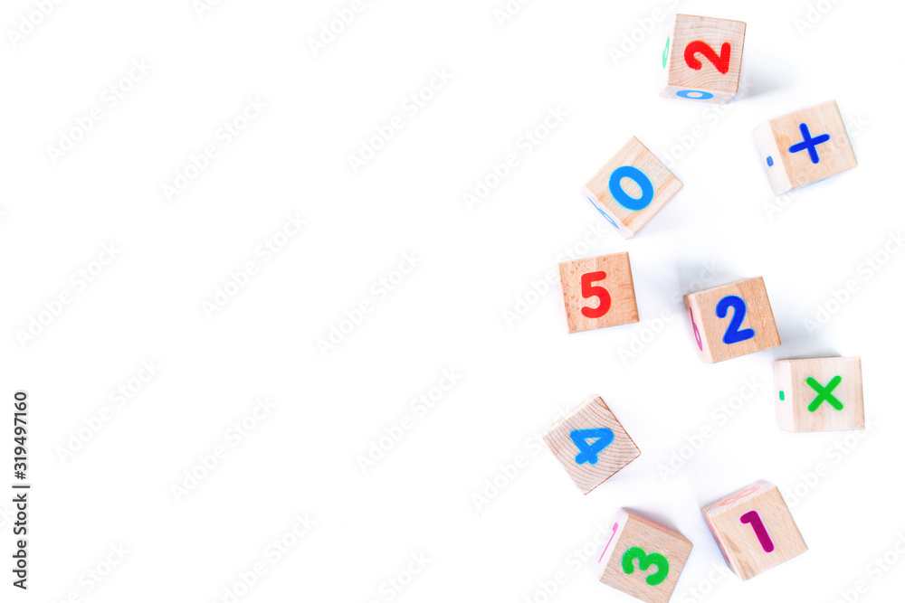Kids toys wooden cubs with numbers on white background. Developing wooden blocks. Natural, eco-friendly toys for children. Top view. Flat lay. Copy space.