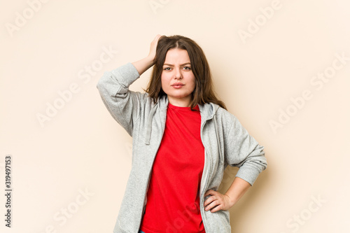 Young sporty curvy woman being shocked, she has remembered important meeting.