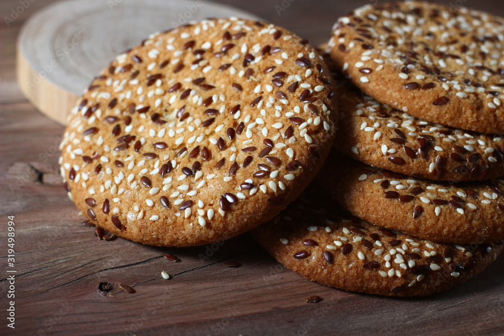 cookies sprinkled with fragrant sesame seeds on a wooden table background