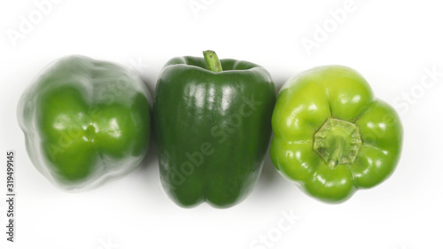 three green peppers on white background.
