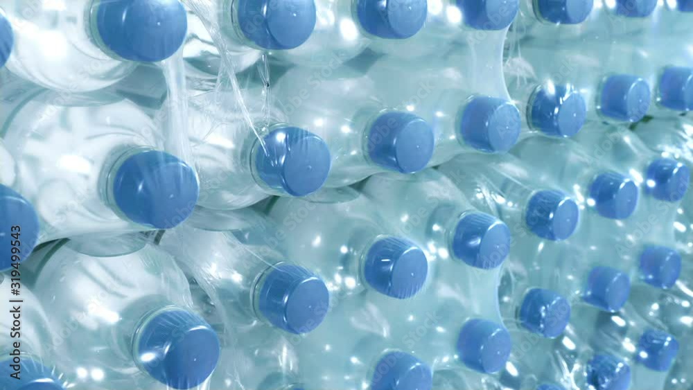 Passing Packages Of Bottled Water Closeup Passing Packages Of Bottled Water Closeup